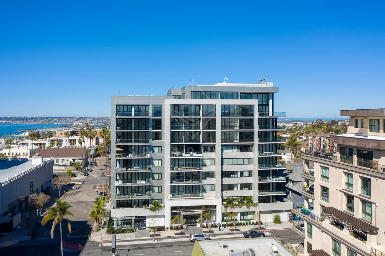Low aerial view of the downtown streets, palm trees and the bay at Bankers Hill.