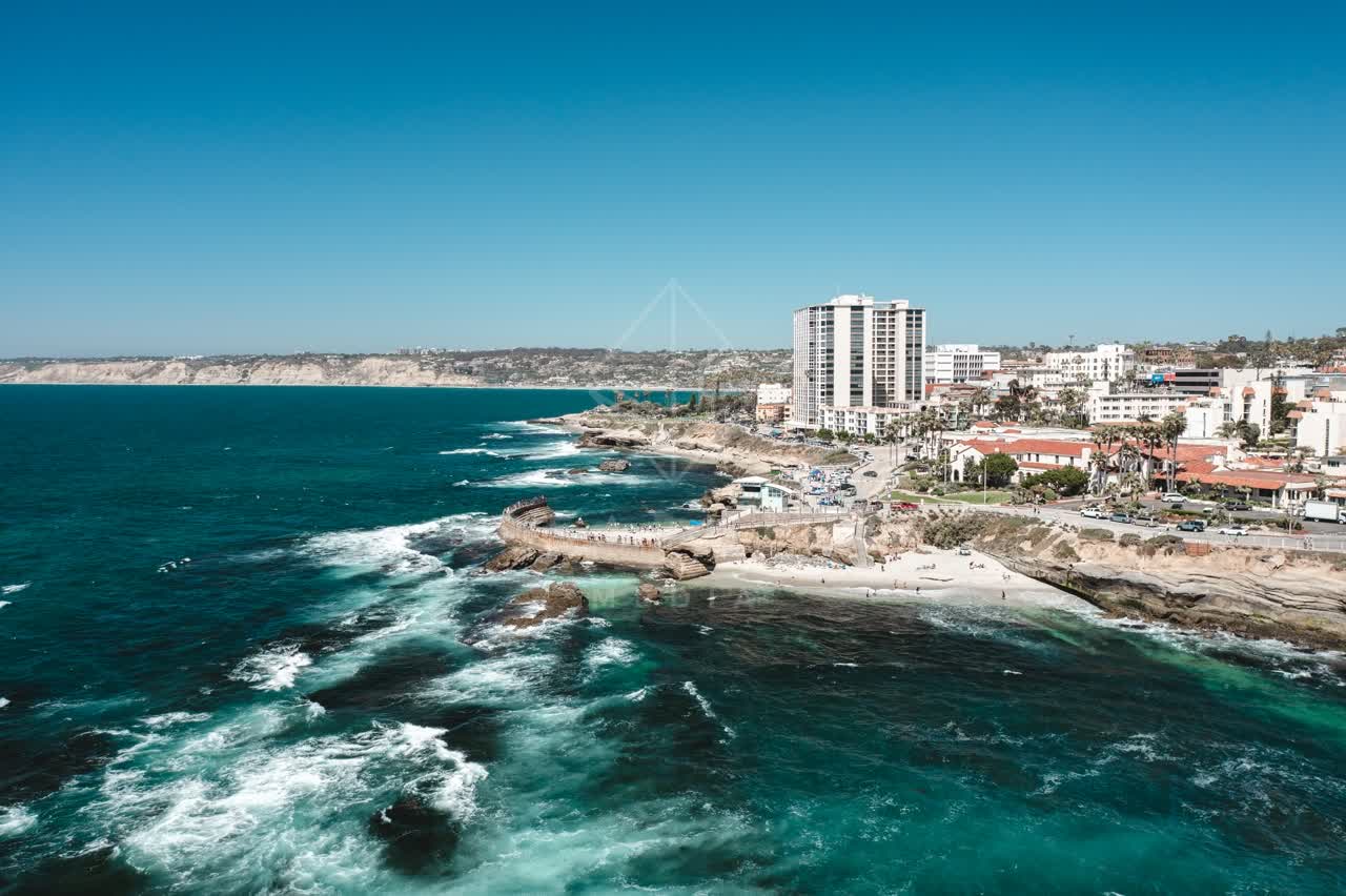 Aerial view of the cliffs, the surf and the ocean at La Jolla Cove.