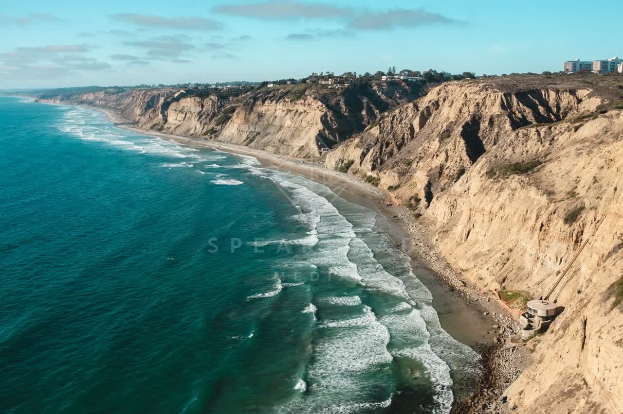 Aerial view of the cliffs, the surf and the ocean at La Jolla Farms.