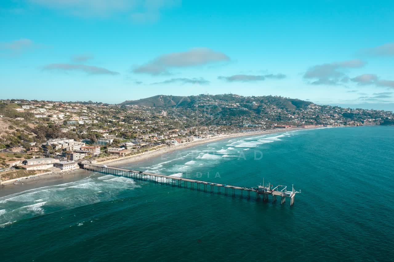 Aerial view of the beach, the surf and the pier at La Jolla Farms.