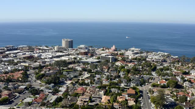 Aerial view of a residential street, boats and the ocean at La Jolla Cove.