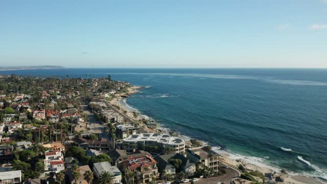 Aerial view of a residential street, palm trees and the ocean at Windansea.