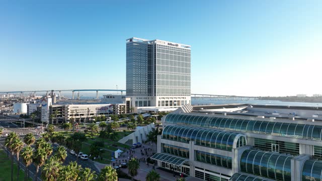 Low aerial view of the downtown streets, the bridge and the skyline at Marina, with a crowd gathered.