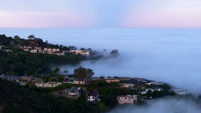 Mount Soledad and the Mt. Soledad National Veterans Memorial over the clouds and fog during an amazing sunrise in La Jolla | Drone Video – 12