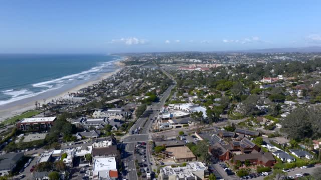 Aerial view of a residential street, the surf and the ocean at Powerhouse Park.