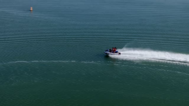 Low aerial view of the country inland, boats and traffic in Carlsbad, with boats out.