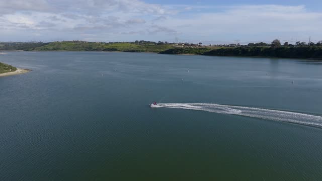Aerial view of the country inland, boats and the bay in Carlsbad, with boats out.