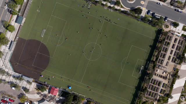 Aerial view of a park, traffic and open country in Carlsbad, with surfers out.