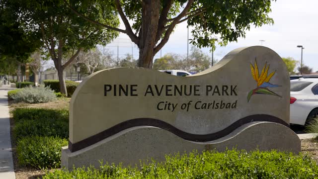 A park, the buildings and traffic in Carlsbad.