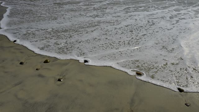 Close view of the beach, the surf and the ocean in Carlsbad.