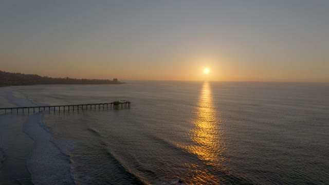 Aerial view of the beach, the surf and the pier at La Jolla Shores.