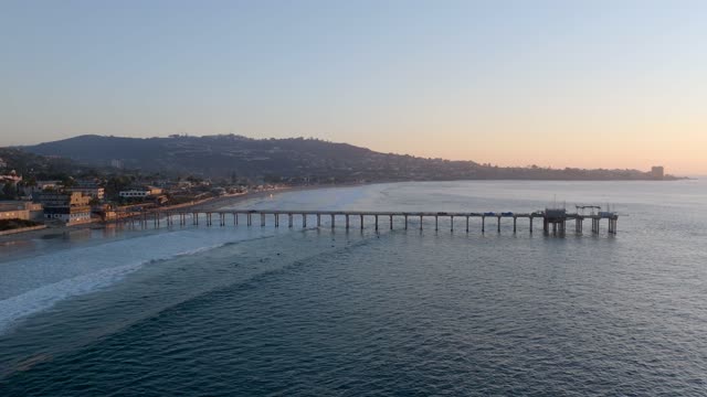 Low aerial view of the beach, the pier and the ocean at La Jolla Shores.