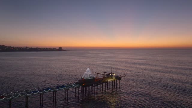 Low aerial view of the beach, the pier and the ocean at La Jolla Shores.