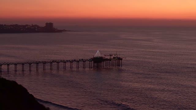 Elevated view of the cliffs, the pier and the ocean at La Jolla Shores.