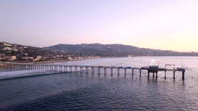 Low aerial view of the beach, the pier and the ocean at La Jolla Shores.