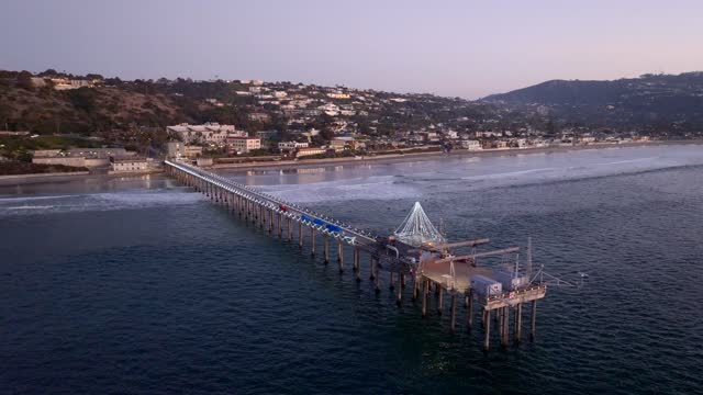 Aerial view of the beach, the surf and the pier at La Jolla Shores.