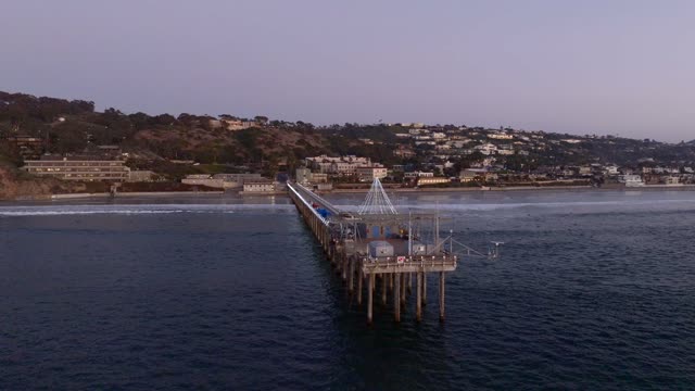 Low aerial view of the beach, the pier and the ocean at La Jolla Shores.
