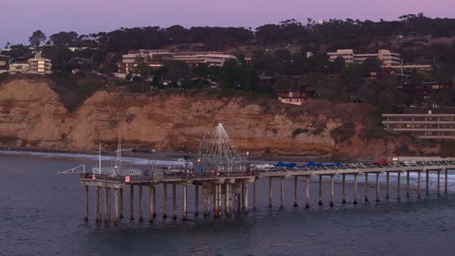 Low aerial view of the beach, the pier and the ocean at La Jolla Shores.