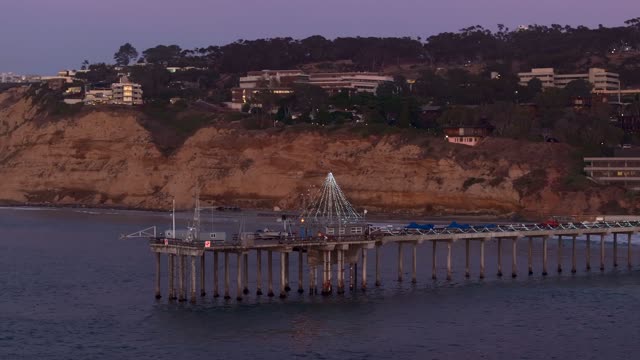 Low aerial view of the beach, the pier and the ocean at La Jolla Shores.