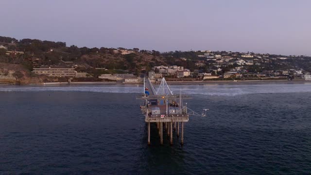 Low aerial view of the beach, the pier and the ocean at La Jolla Shores.
