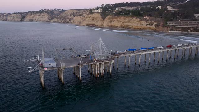 Low aerial view of the beach, the pier and the ocean at La Jolla Shores.