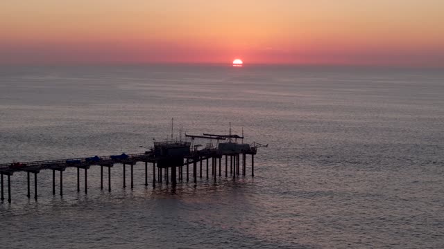 Low aerial view of the beach, the pier and the ocean at La Jolla Shores.