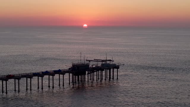 Low aerial view of the beach, the pier and the ocean at La Jolla Shores.