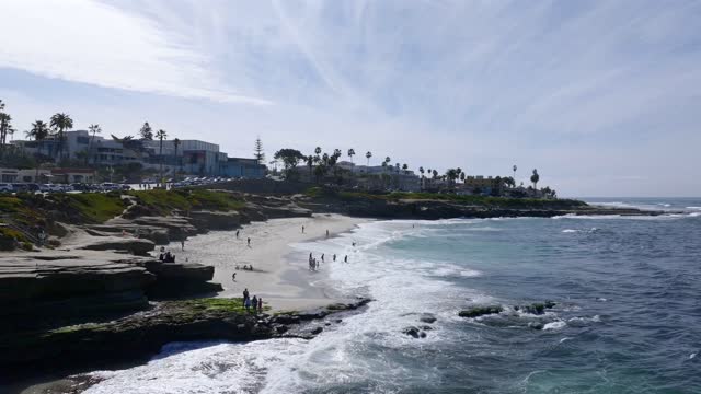 Aerial shot of Wipeout Beach in La Jolla on a beautiful Day with Blue Skies | Drone Video