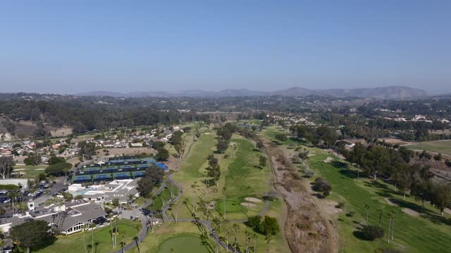 Aerial view of a residential street, palm trees and homes in Rancho Santa Fe.