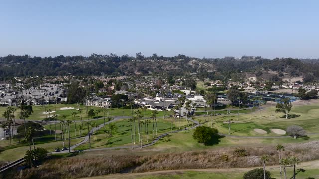 Aerial view of a residential street, palm trees and homes in Rancho Santa Fe.