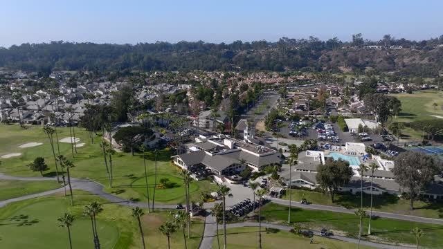 Aerial view of a residential street, palm trees and homes in Rancho Santa Fe.