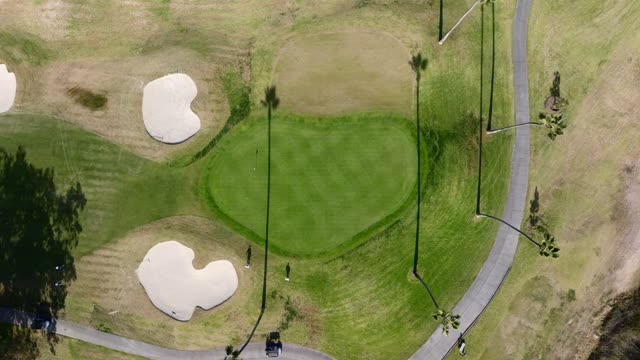 Aerial view of a park, traffic and open country in Rancho Santa Fe, with people walking.