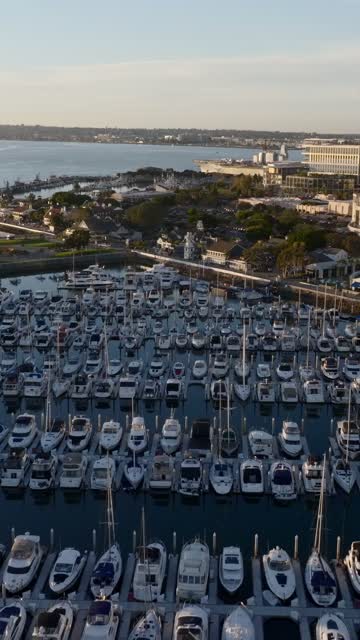 Aerial view of the USS Midway and Marina District of downtown San Diego during golden hour | Vertical Drone Video – 2