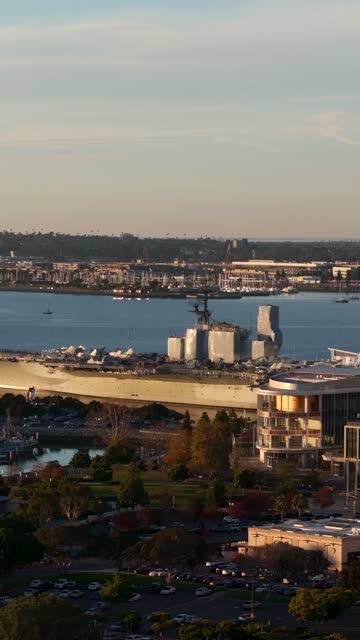 Aerial view of the USS Midway and Marina District of downtown San Diego during sunset | Vertical Drone Video – 1