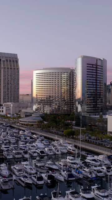 Aerial view of the Marriott Marquis in the Marina District of downtown San Diego during sunset | Vertical Drone Video