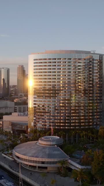 Aerial view of the Marriott Marquis in the Marina District of downtown San Diego during sunset | Vertical Drone Video – 1