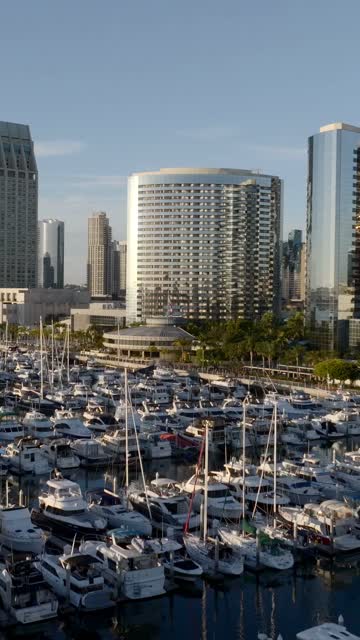 Aerial view of the Marriott Marquis in the Marina District of downtown San Diego during sunset | Vertical Drone Video – 2