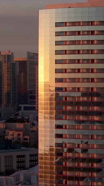 Aerial view of the Marriott Marquis in the Marina District of downtown San Diego during sunset | Vertical Drone Video – 3