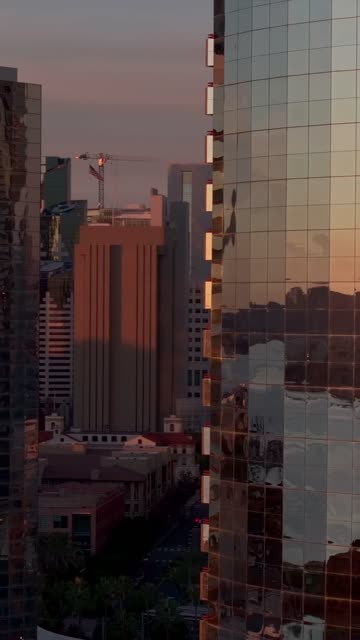 Aerial view of the Marriott Marquis in the Marina District of downtown San Diego during sunset | Vertical Drone Video – 4