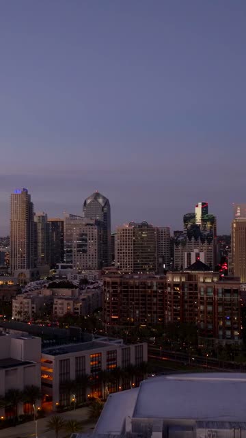Aerial view of the San Diego skyline and Marriott Marquis in the Marina District of downtown San Diego during sunset | Vertical Drone Video