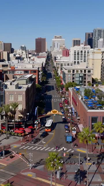 Aerial view of the Gaslamp Quarter sign and 5th Ave in downtown San Diego on a clear sunny day | Vertical Drone Video – 1