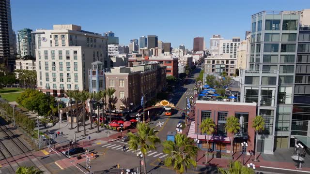 Aerial view of the Gaslamp Quarter sign and 5th Ave in downtown San Diego on a clear sunny day | Drone Video