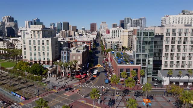 Aerial view of the Gaslamp Quarter sign and 5th Ave in downtown San Diego on a clear sunny day | Drone Video – 1