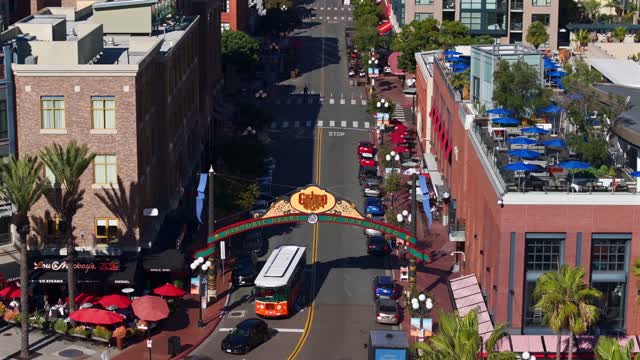 Aerial view of the Gaslamp Quarter sign and 5th Ave in downtown San Diego on a clear sunny day | Drone Video – 2