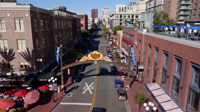 Aerial view of the Gaslamp Quarter sign and 5th Ave in downtown San Diego on a clear sunny day | Drone Video – 3