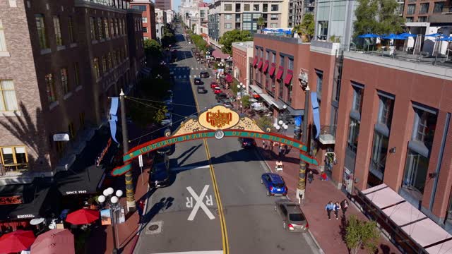 Aerial view of the Gaslamp Quarter sign and 5th Ave in downtown San Diego on a clear sunny day | Drone Video – 4