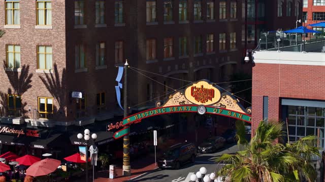 Aerial view of the Gaslamp Quarter sign and 5th Ave in downtown San Diego on a clear sunny day | Drone Video – 5