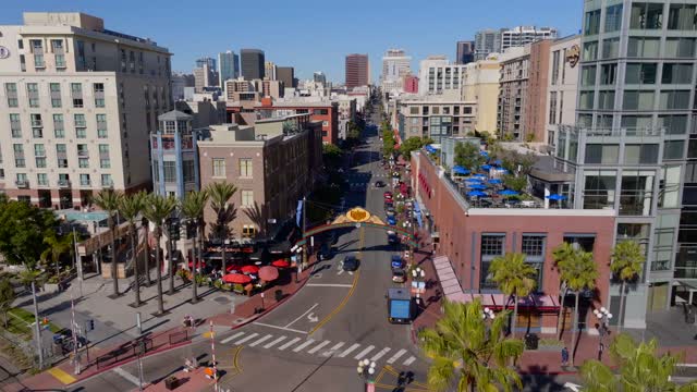 Aerial view of the Gaslamp Quarter sign and 5th Ave in downtown San Diego on a clear sunny day | Drone Video – 6