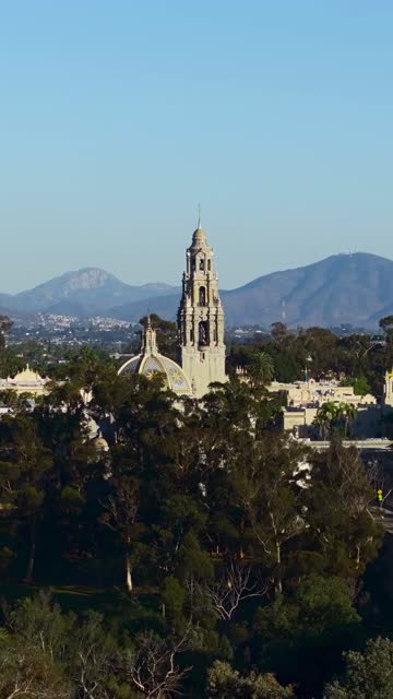 Low aerial view of a park, the buildings and open country in Balboa Park.