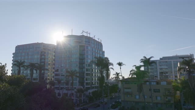 Low aerial view of the downtown streets, palm trees and homes at Bankers Hill.